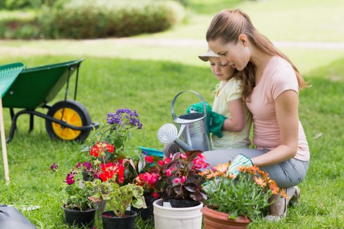 Worker using protective equipment during landscaping tasks